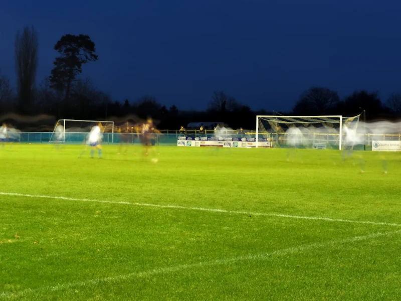 A floodlit football pitch at dusk.
